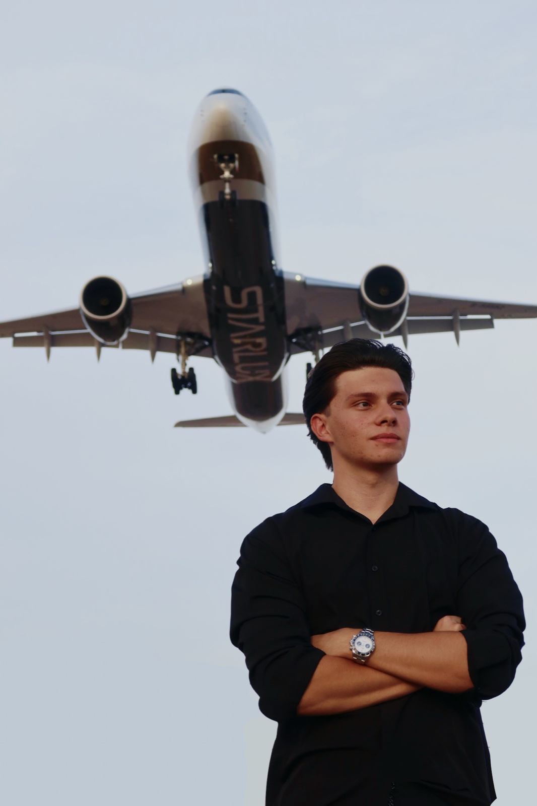 Andrew Cimpean with an aircraft on approach in the background